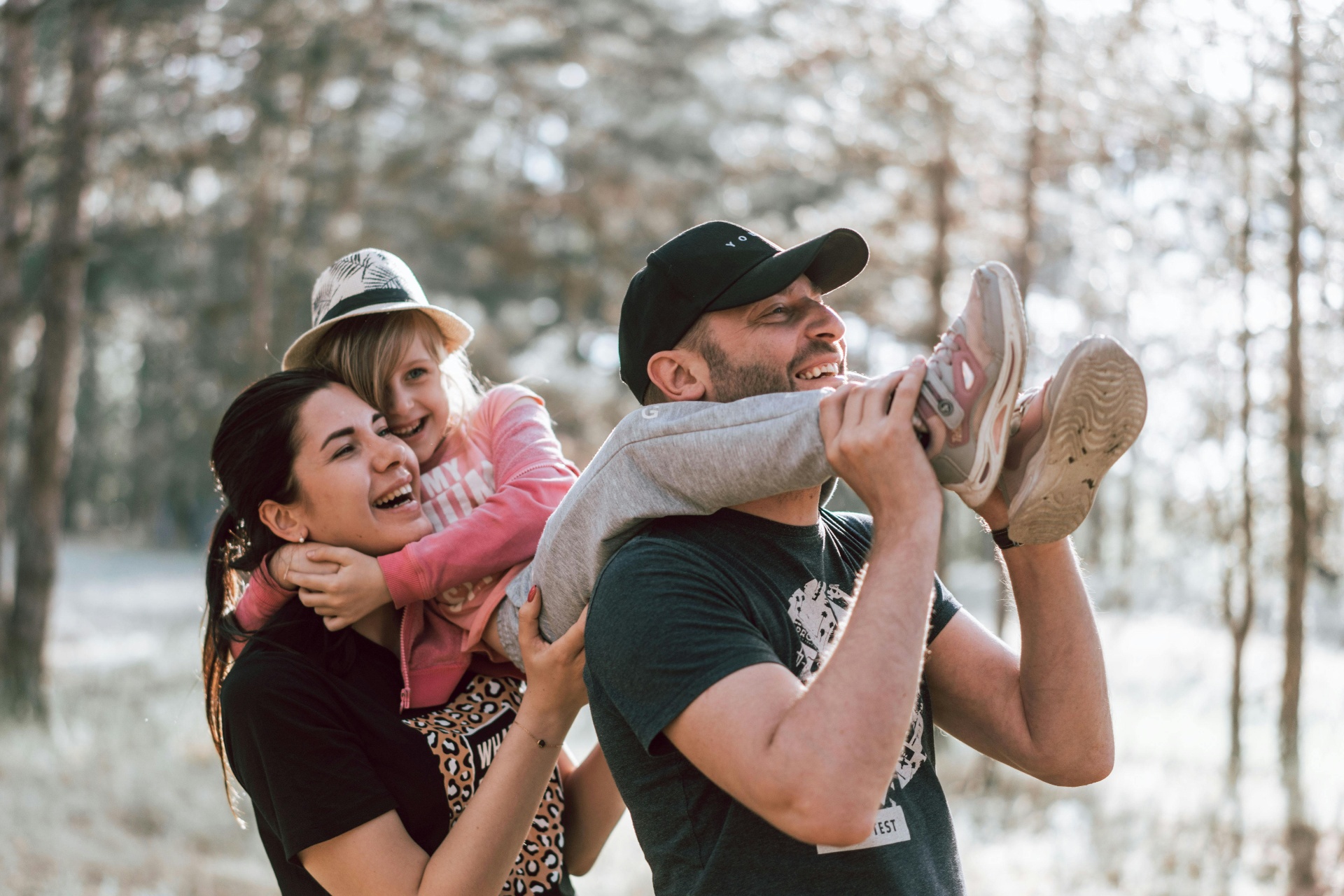 Parents playing with their child outdoors